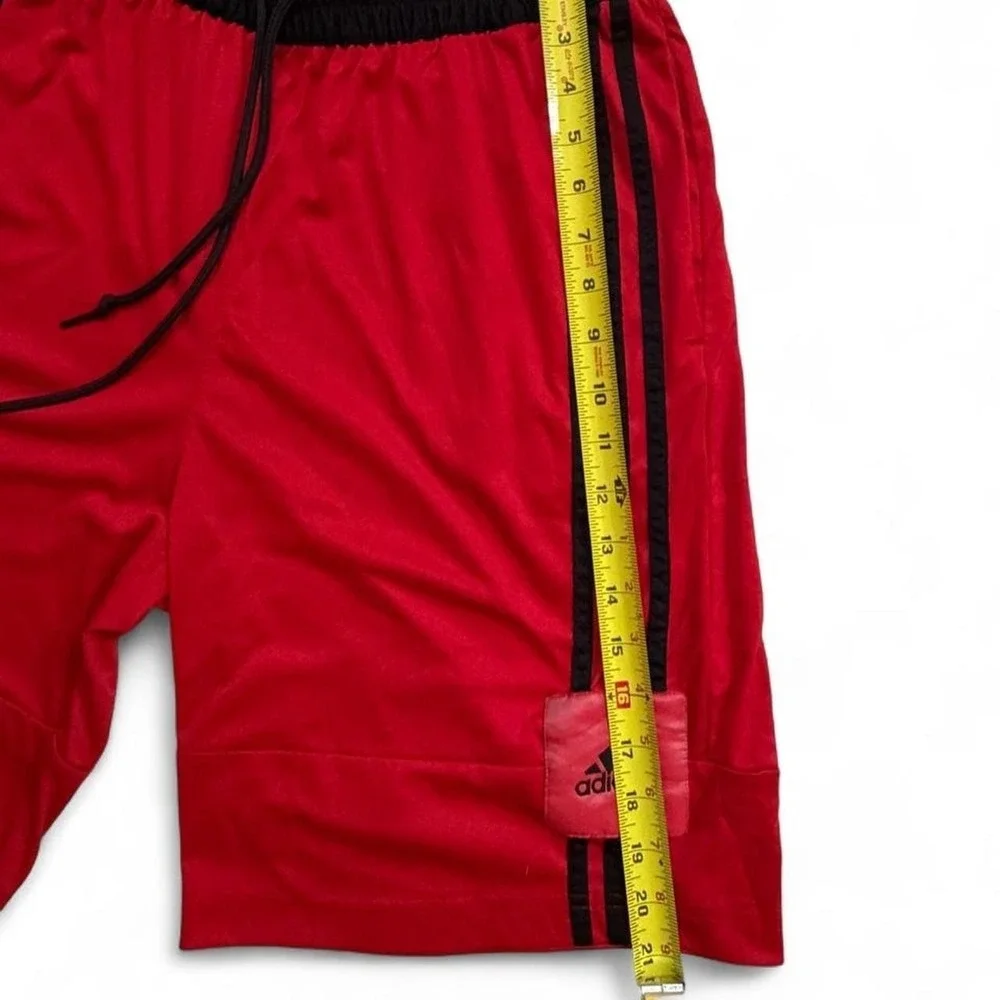 Adidas red shorts with black stripes